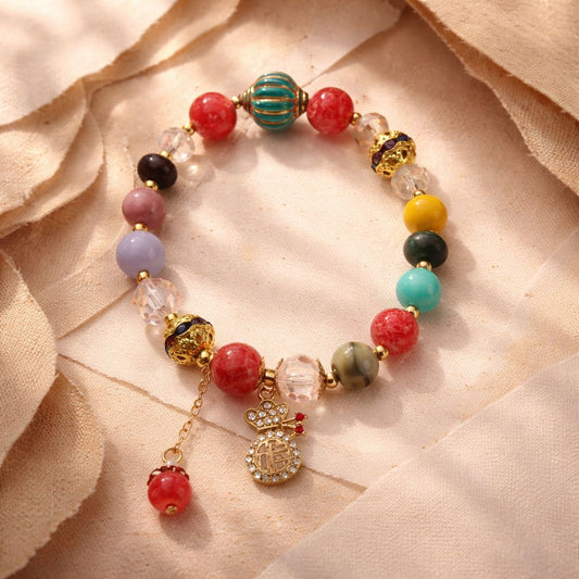 Pulsera de diferentes gemas y resinas con saquito de la fortuna y felicidad